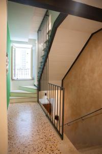 a spiral staircase in a room with a window at Verde romantico in Città della Pieve
