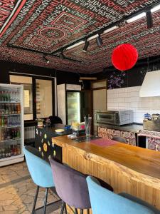 a kitchen with a bar and chairs in a restaurant at Guest House Seno in Dilijan