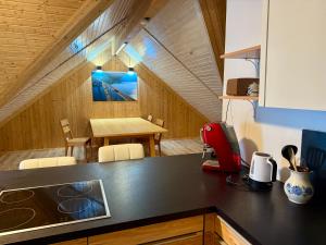 a kitchen with a counter top and a dining room at Das Holzhaus in Haidershofen