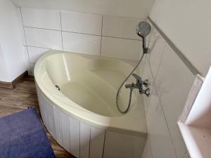 a bath tub in a bathroom with a shower at Das Holzhaus in Haidershofen +11 photos
