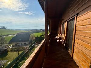 a balcony of a house with a view of the countryside at Das Holzhaus in Haidershofen