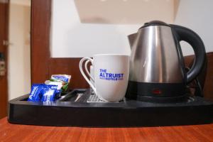a coffee pot and a coffee mug on a tray at The Altruist Andheri Hotel in Mumbai