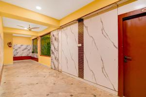 a hallway with yellow walls and a marble wall at Super Collection O Rajarhat Formerly Redstone in Kolkata