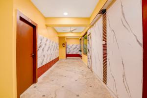 a corridor of a room with yellow walls and a door at Super Collection O Rajarhat Formerly Redstone in Kolkata +30 photos
