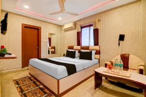a bedroom with a large bed and a table at Super Collection O Rajarhat Formerly Redstone in Kolkata