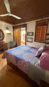 a bedroom with a large bed with a blue comforter at Luxury Casa Cindy in Puerto Escondido