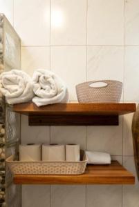 a wooden shelf with towels and baskets in a bathroom at Luxury Casa Cindy in Puerto Escondido +50 photos