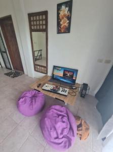 a room with two purple bean bags on the floor at White beach Villa in Panglao Island +14 photos