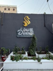 a sign on a wall with a bunch of bananas at Crystal Crown Hotel in Peshawar