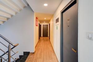 a hallway with stairs and a door in a building at OYO Townhouse Singapore Mall Formerly Hotel Sunshine in Lucknow
