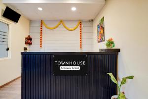 a view of a front desk with a town house sign on it at OYO Townhouse Singapore Mall Formerly Hotel Sunshine in Lucknow