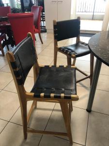 a pair of chairs sitting next to a table at Cairns Apartment Esplanade Ocean Views in Cairns