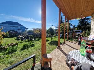 a person sitting at a table in a pavilion at Orbis Bude in Samshvilde