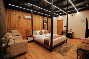 a bedroom with a bed and a couch in it at HoneyStone Resort in Sultan Bathery