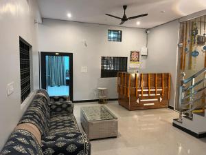 a living room with a couch and a table at Shyam Hotel & Janmasa in Rewa