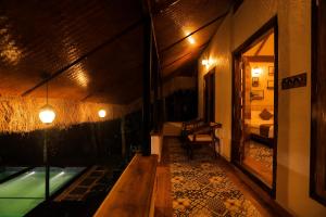 a hallway of a room with a pool and a bed at HoneyStone Resort in Sultan Bathery