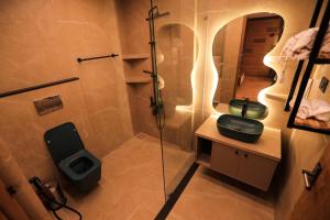 a bathroom with a shower and a toilet and a sink at HoneyStone Resort in Sultan Bathery +69 photos