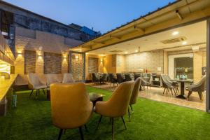 a patio with chairs and tables in a building at Hotel Vanson Villa, City Centre - With Free Airport & Train Station Pickup in New Delhi