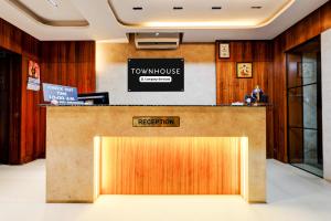 a hotel lobby with a front desk with a townhouse reception at Townhouse GIDC Ankleshwar Formerly Studio 60 in Kosamri
