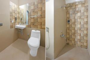 a bathroom with a toilet and a sink at Townhouse GIDC Ankleshwar Formerly Studio 60 in Kosamri