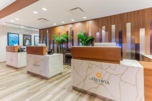 a lobby of a hotel with tables and plants at La Quinta Inn & Suites by Wyndham Chicago Downtown in Chicago