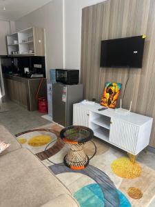 a living room with a couch and a tv at Edwin homes in Nairobi
