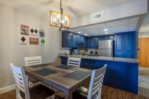 a kitchen with a wooden table and blue cabinets at Park Plaza Resort - Park City, Ascend Collection Hotel in Park City