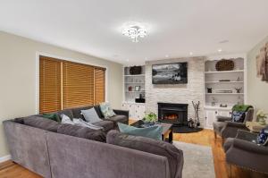a living room with a couch and a fireplace at Summit Chalet at Stillwater in Pocono Summit