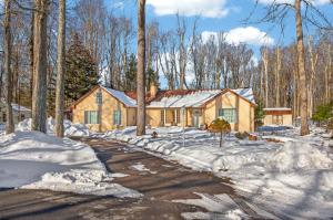 a house in the snow with a driveway at Summit Chalet at Stillwater in Pocono Summit