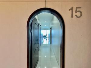 a hallway with a mirror and a number on the wall at Mar y Sol 15th Floor 3BR 2 BA Condo with pool in Rosarito