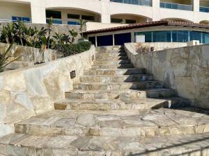 a set of stone stairs in front of a building at Mar y Sol 15th Floor 3BR 2 BA Condo with pool in Rosarito