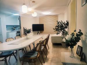 a living room with a large white table and chairs at stay young in Suwon
