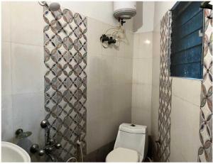 a bathroom with a toilet and a sink and a shower at Hotel O Krishna Bhawan in kolkata