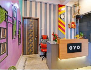a office with a red chair in front of a desk at Hotel O Krishna Bhawan in kolkata