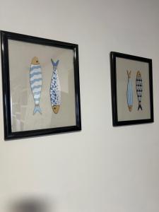 two framed pictures of surfboards hanging on a wall at Puerto de Bueu, Centro in Bueu