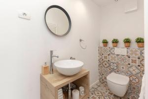 a bathroom with a sink and a mirror on the wall at New Apartments Škofije Ankaran in Koper
