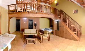 a living room with a spiral staircase in a house at Upasana Retreat in Kalasa