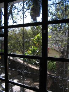 a view through a window of a garden at Hotel Pousada Hospedaria Antiga in Ouro Preto