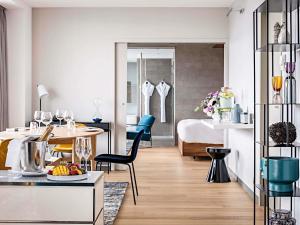 a living room and dining room with a bedroom at Pullman Paris Tour Eiffel in Paris