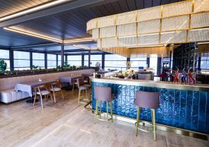 a restaurant with a bar and tables and chairs at DoubleTree by Hilton Ankara Incek in Ankara