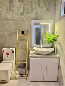 a bathroom with a sink and a mirror on a counter at Villa Lithu in Weligama