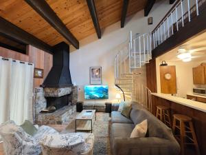 a living room with a couch and a fireplace at Spiral Staircase home in Kings Beach +27 photos