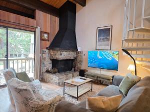 a living room with a couch and a fireplace at Spiral Staircase home in Kings Beach