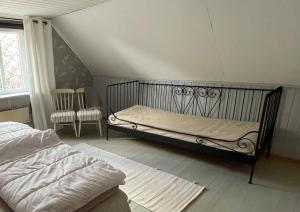 a bedroom with a bed in a room at Österlen - Gathus in Onslunda in Onslunda