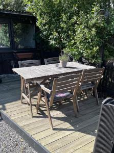 a wooden picnic table and bench on a deck at Österlen - Gathus in Onslunda in Onslunda +13 photos