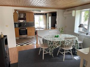 a kitchen and dining room with a table and chairs at Österlen - Gathus in Onslunda in Onslunda