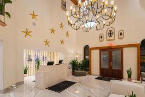 a lobby with a chandelier and stars on the wall at Castillo Real St Augustine Beach,Tapestry Collection Hilton in Saint Augustine Beach +111 photos