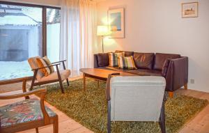 a living room with a couch and a table at 3 Bedroom Nice Home In Simrishamn in Simrishamn
