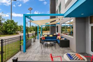 a patio with a couch and a table on a building at Tru By Hilton Augusta Washington Road in Augusta