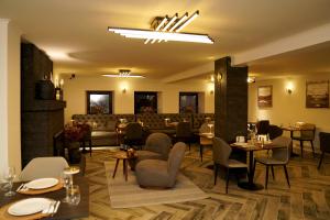 a restaurant with tables and chairs and a bar at EL hotel in Kutaisi